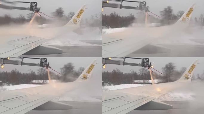 暴风雪极端天气机场对飞机客机进行除冰作业