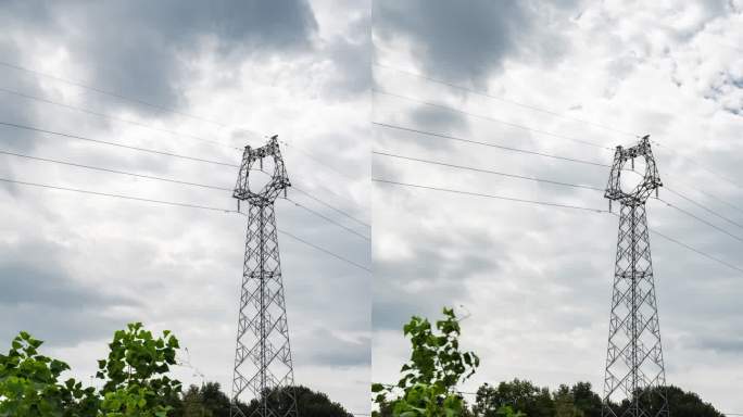 低视角拍摄乌云笼罩下桂林田野中的输电塔