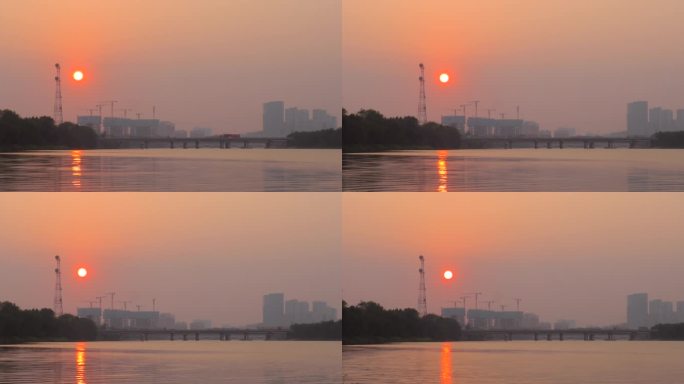 河边落日夕阳西下水天一色太阳照在水面上