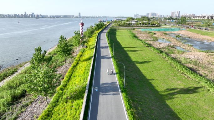 骑行爱好者在长江边环岛路上骑自行车运动