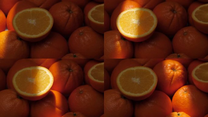 橙色水果。一束光照亮了阴影中切开的橘子。特写镜头