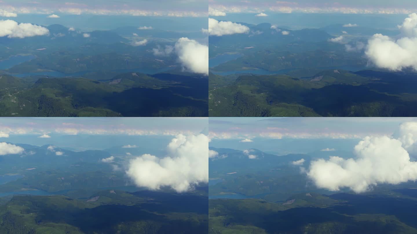 飞机在云层上飞行。陆地和山脉的景色