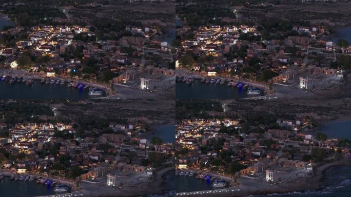 鸟瞰图飞过Side老城码头和照明的土耳其海滨社区