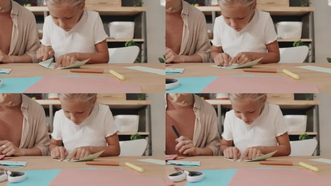 创意母亲和女孩创造纸人物