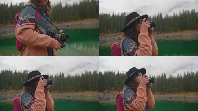 秋天，一名女子拿着相机站在卡雷扎湖附近