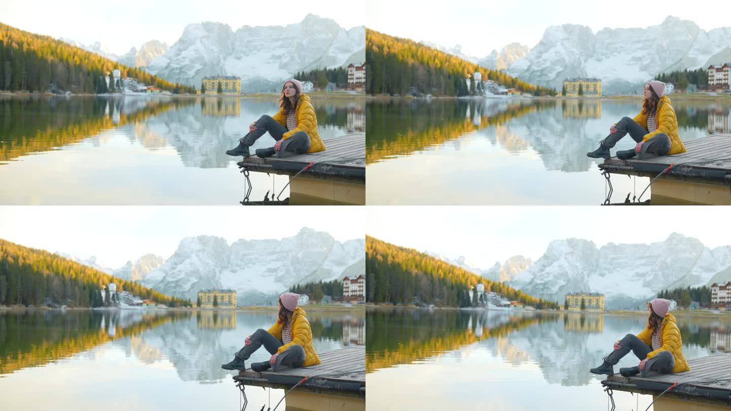 秋天，女子坐在白云石湖的背景上