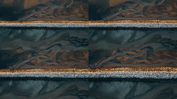 日落时分，普罗温斯敦的岩石防波堤自上而下下降的照片-地面上的水的图案