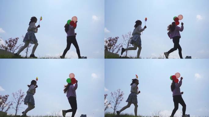 年轻妈妈陪伴孩子手拿 气球逆光奔跑