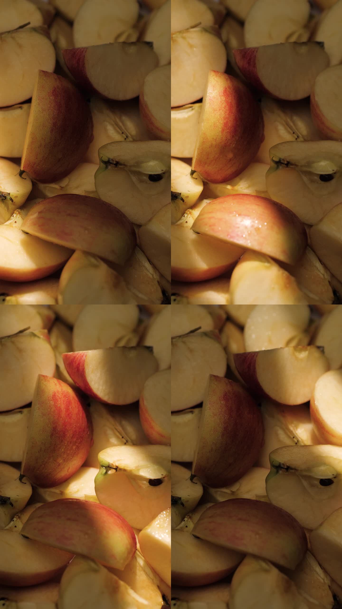 切苹果。阳光落在苹果片上的垂直视频