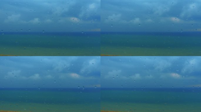 玻璃窗，海景。深海。地平线上乌云密布。风暴警告。雨滴滴落的特写镜头。水从窗户流下来。天气预报。远处乌