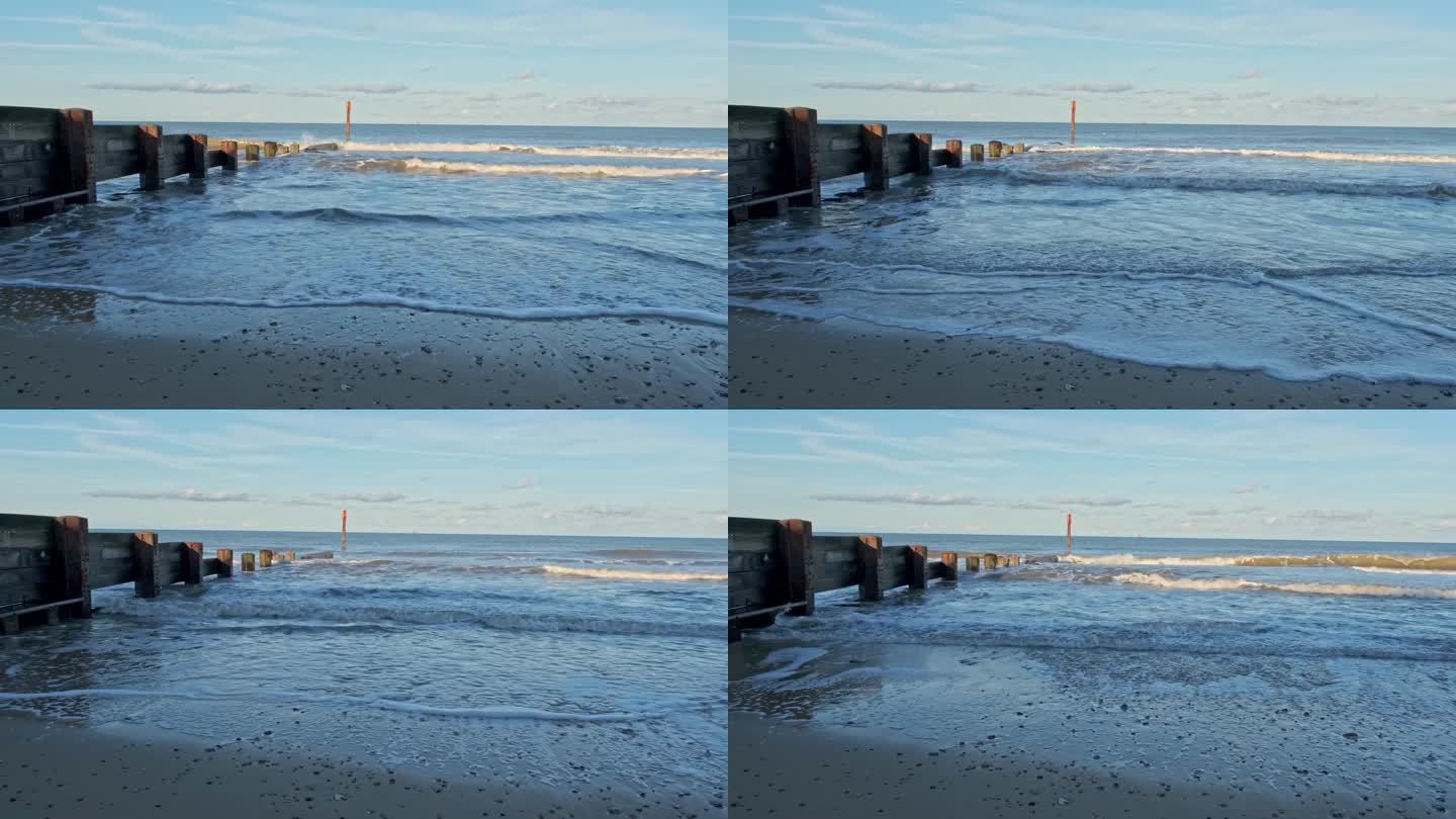 海浪冲击着海岸上的木制石阵