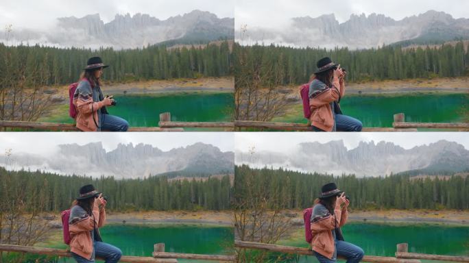 秋天，一名女子拿着相机站在卡雷扎湖附近