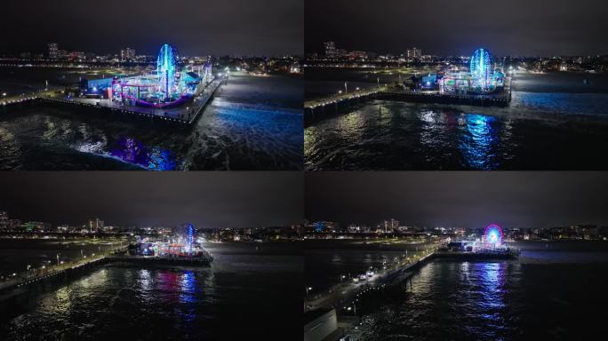 航拍照片在夜晚向后飞过圣莫尼卡码头