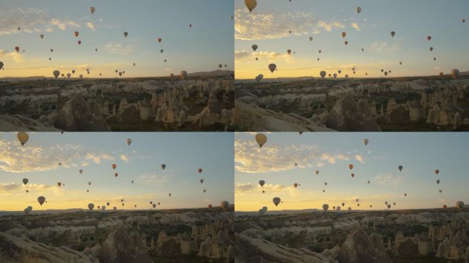 黎明时分从卡帕多西亚的爱之谷拍摄的全景，众多的热气球充满了整个天空。