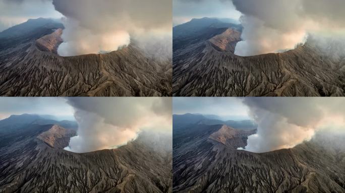 空中无人机拍摄的火山喷发日落场景，被云、雾和烟包围的Bromo火山与塞默鲁山、Batok和Widod