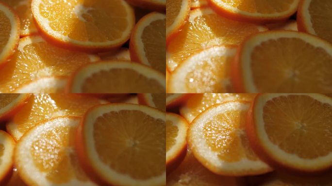 橙色水果。微距镜头缓慢移动，显示阴影中切片的新鲜多汁橙子，橙子被阳光照射