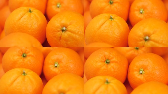 橙色水果。镜头缓缓向上移动，呈现新鲜橙子的特写