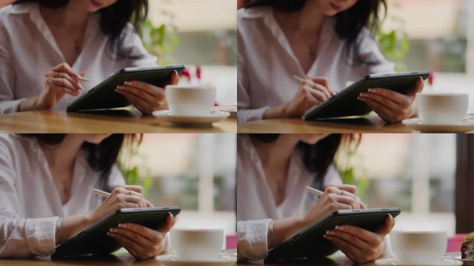 女平面设计师与平板电脑和手写笔在咖啡馆工作，绘制数字图片，特写