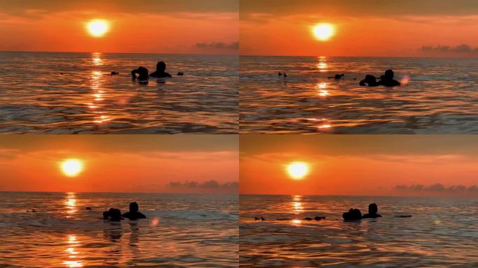 日落时分，一家人在海边玩耍，一起在海滩度假。