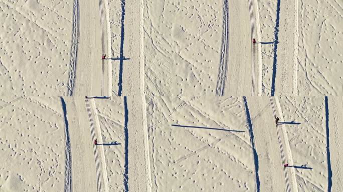 在一个美丽的冬日阳光明媚的日子里，难以辨认的人在越野滑雪