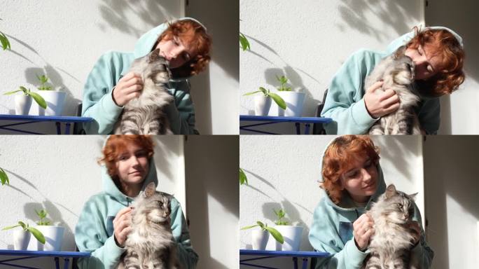 十几岁的红发女孩和毛茸茸的绿眼睛猫的肖像