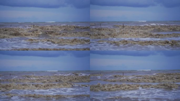 海滩上波涛汹涌，海水浑浊。