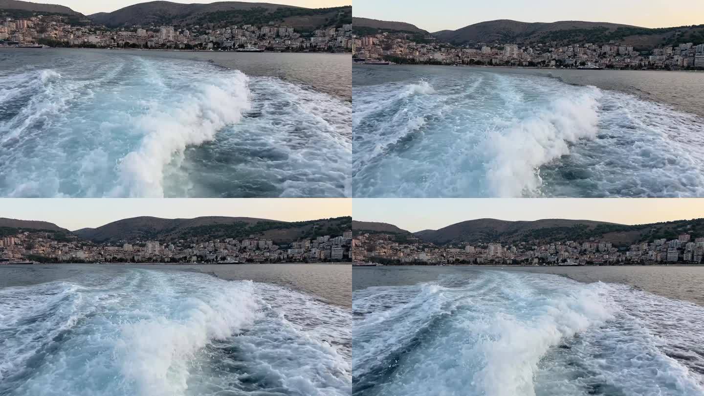 从一艘从圣托里尼岛开往纳克索斯岛和希腊爱琴海的雅典的轮渡的后面看到的风景