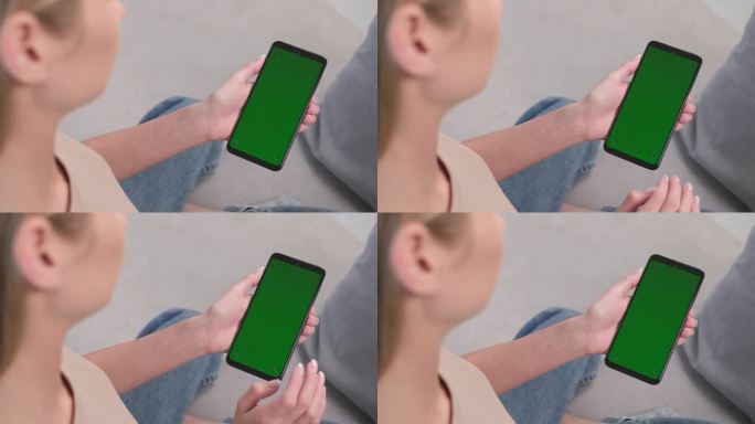 一位女士坐在家里的沙发上，在绿色的手机屏幕上做了一个向左滑动的手势。猪在左边。