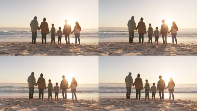 一家人手牵着手，背后的大海和阳光，祖父母和父母带着孩子在海滩上。爱，关怀和支持，假期和团结，女人和男