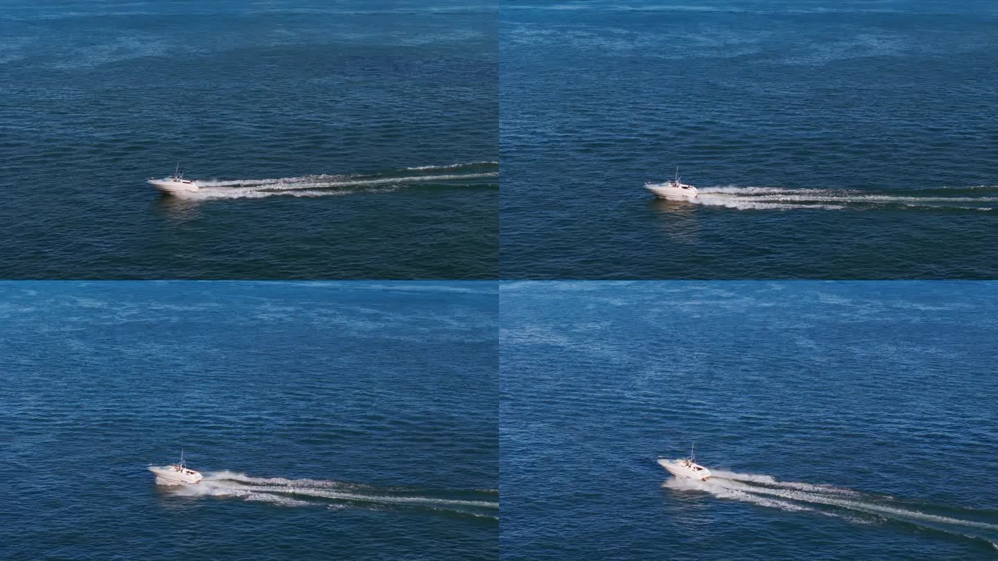 航拍放大图，一艘白色的船驶向蓝色的大海。高速移动的。慢动作