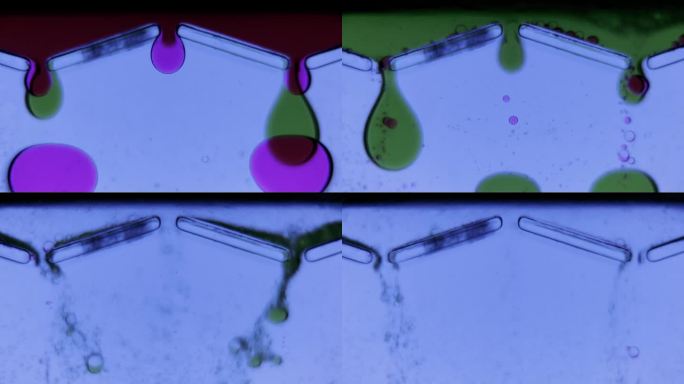 微观世界中的液体气泡。绿色和紫色的液体从三个开口流出。