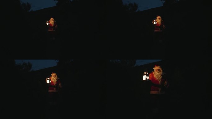 圣诞老人提着礼物和灯笼在黑暗中走着