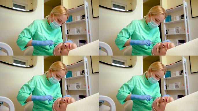 戴着手套的美容师在做皮肤拉皮注射。病人接受整容手术