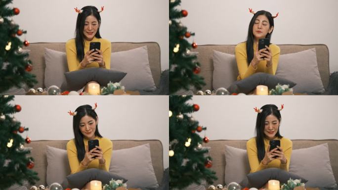 迷人的年轻亚洲女性或十几岁的女孩微笑着看智能手机，手机聊天或使用社交媒体与朋友交谈，在圣诞装饰客厅感