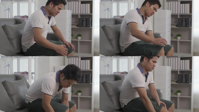 年轻的亚洲男子肌肉疼痛在他的手臂，腿和膝盖，感觉疼痛在他的肘部，肌肉疼痛保健概念