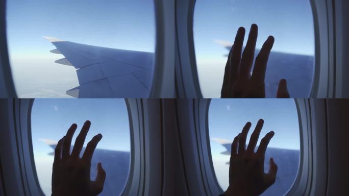 旅客的手触摸飞机的窗户