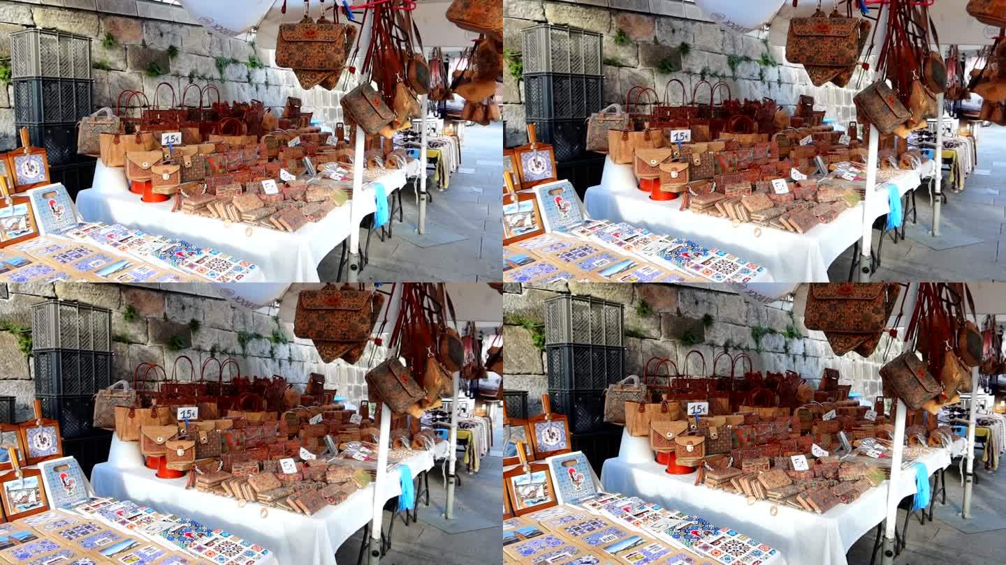 在波尔图的Cais da Ribeira街头市场，有手工制作的包和瓷砖。广角镜头