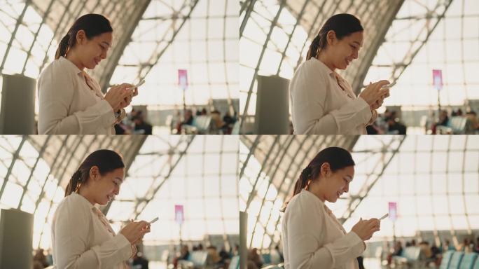女子在机场使用智能手机