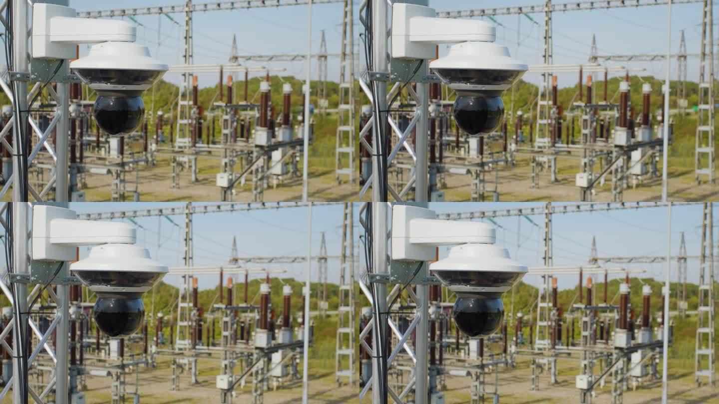 电线杆上的监控摄像头在模糊的背景中有变电站和电线