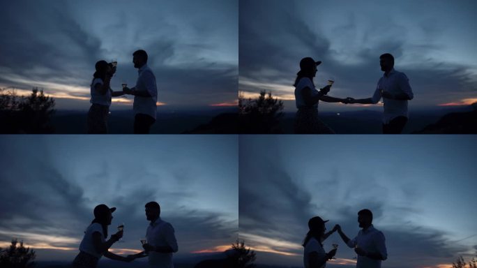 男人和女人在草地上喝酒跳舞，一起享受生活