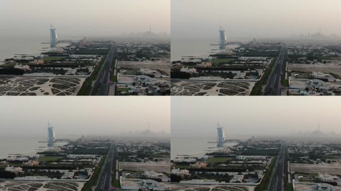 波斯湾岸边的阿拉伯塔酒店和地平线上烟雾缭氲的迪拜