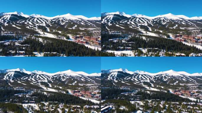 空中无人机拍摄的令人惊叹的山坡滑雪斜坡视频。许多冬季运动的小径覆盖在山峰上的厚粉秀