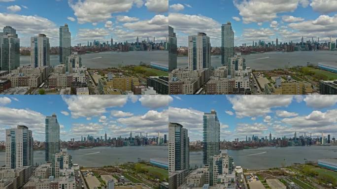 鸟瞰图的豪华镜面建筑，在格林威治布鲁克林区滨水区的看法，在纽约市天际线背后的东河-缓慢向前飞行