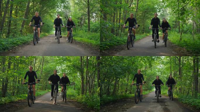 三个女人朋友或姐妹一起骑自行车在美丽的森林在阳光明媚的夏日