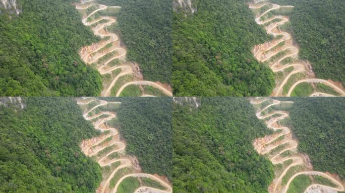 在越南曹邦茂密的热带丛林中，无人机在曲折的山口向后移动