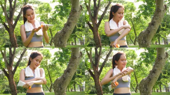 年轻运动的亚洲女子跑步者在早上跑步前，站着在手上和手臂上涂上防晒乳液，以保护和护理皮肤。面霜防晒、护