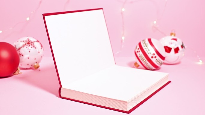 圣诞红书:一个定格动画视频，一个红色的书打开，露出圣诞装饰品