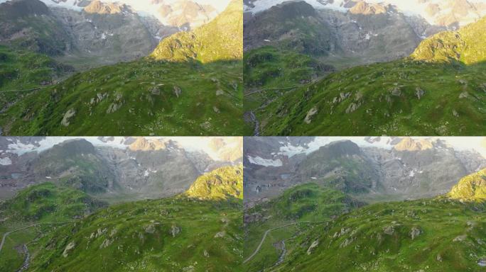 无人机捕捉到令人惊叹的山顶，有很多树和草。在另一岸，山与云相连。瑞士境内的阿尔卑斯山。高品质4k画面