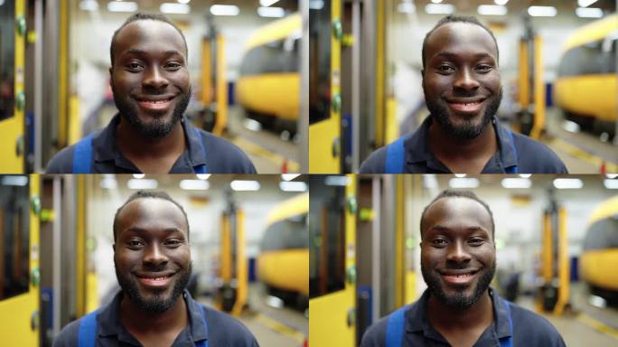 铁路车间里微笑的年轻维修工程师的特写肖像