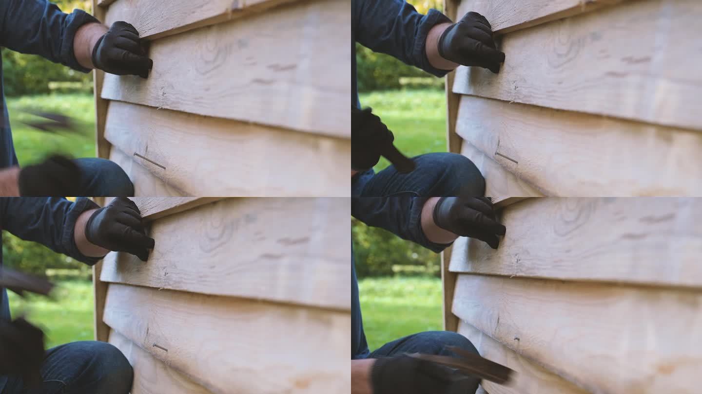 男工用手在外立面钉木制挡风板